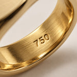 The 750 hallmark struck into every Aquae Jewels piece, certifying solid 18K gold
