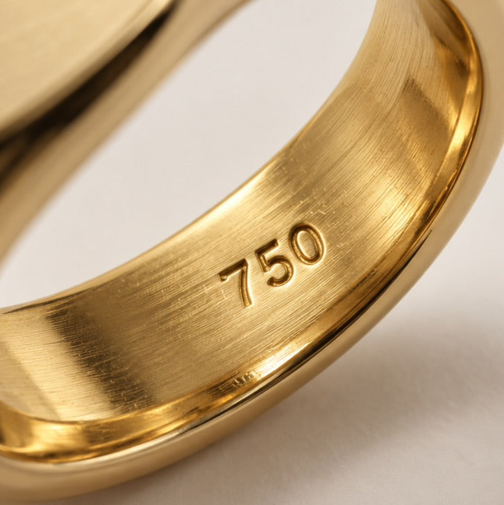 The 750 hallmark struck into every Aquae Jewels piece, certifying solid 18K gold