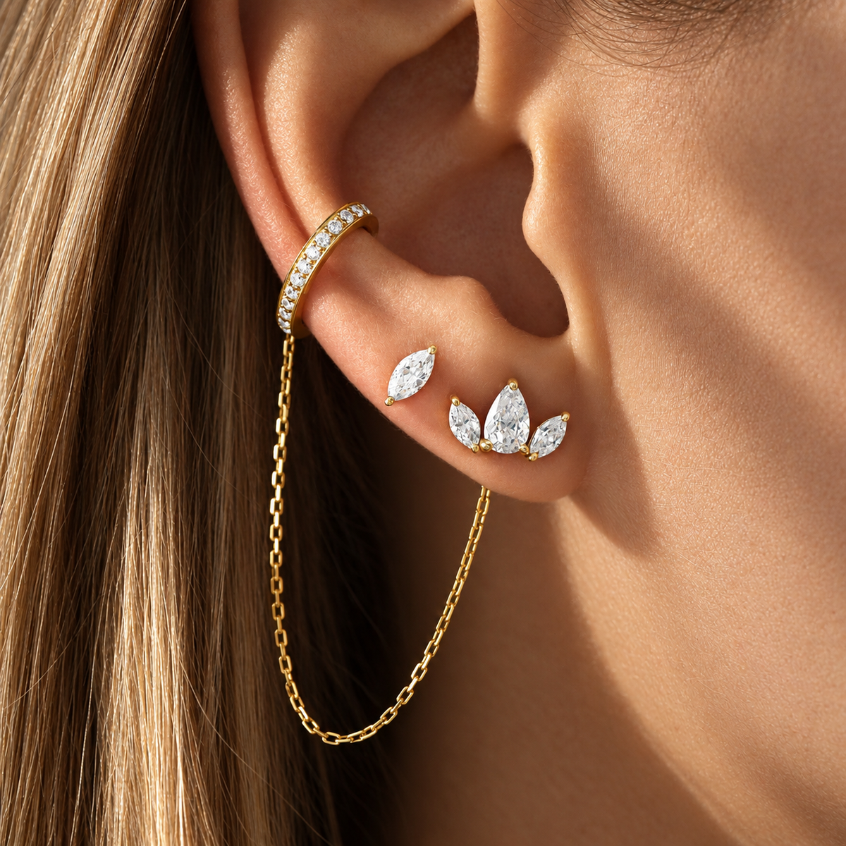 Marquise Stud Earrings worn on the ear, solid 18K gold and diamonds, by Aquae Jewels