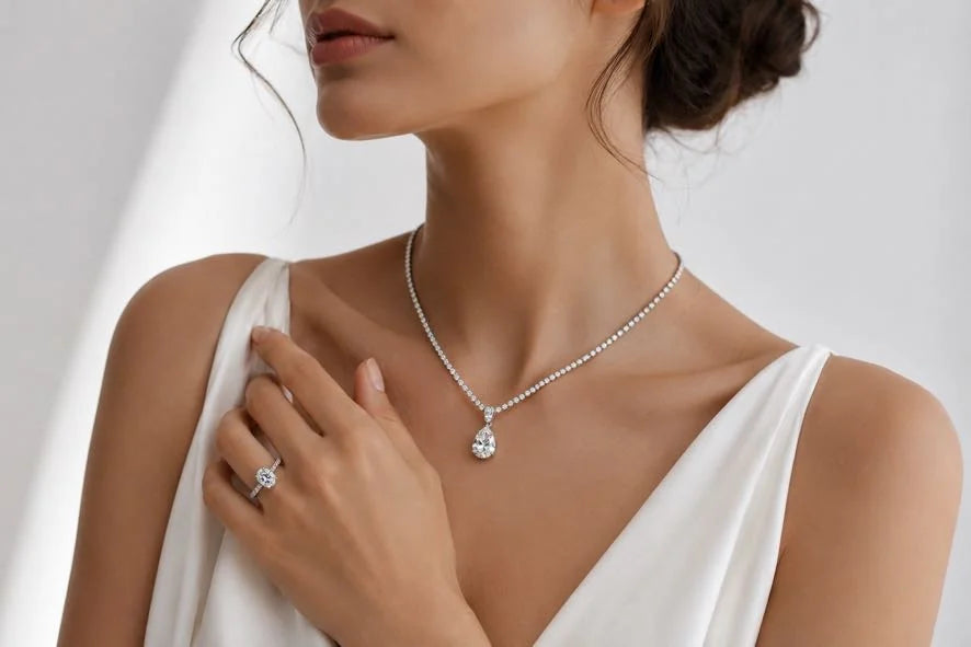 Woman wearing Aquae Jewels diamond pendant necklace and engagement ring handcrafted in solid 18K gold with natural diamonds