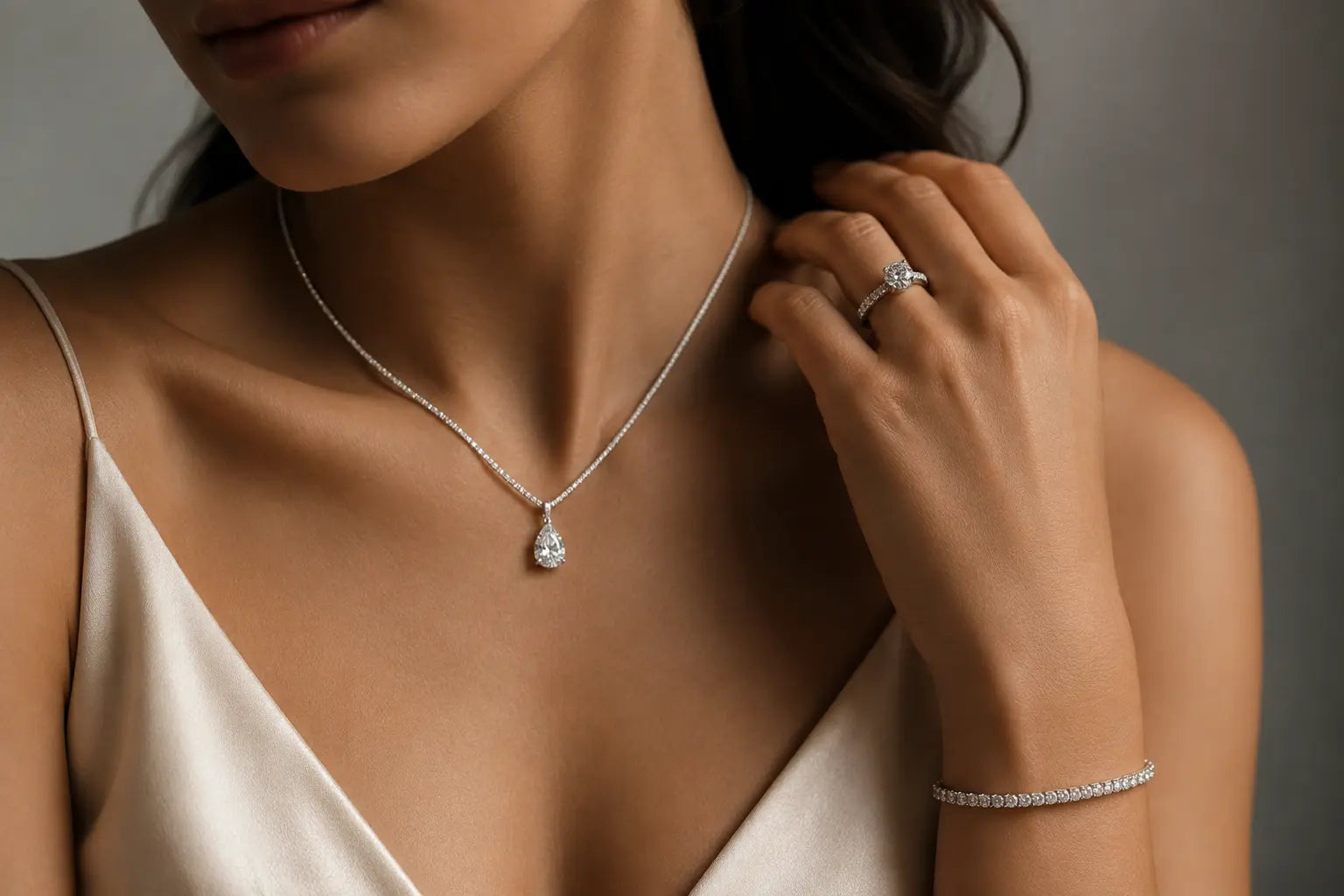 Woman wearing an Aquae Jewels diamond pendant necklace, engagement ring and tennis bracelet handcrafted in solid 18K gold with natural diamonds